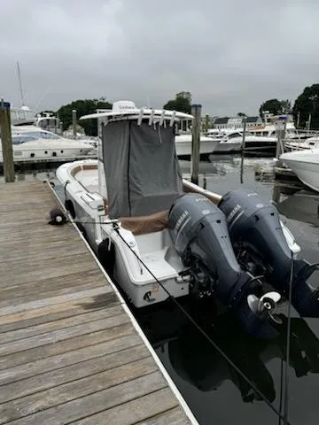 Slide: The Image of 2022 Sea Hunt Ultra 265 SE boat docked with dual outboard motors. - 3