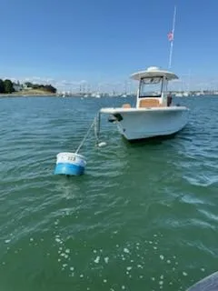 Slide: The Image of 2022 Sea Hunt Ultra 265 SE boat moored on calm water with buoy. - 5