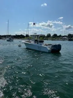 Slide: The Image of 2022 Sea Hunt Ultra 265 SE boat on calm water under a sunny sky. - 7