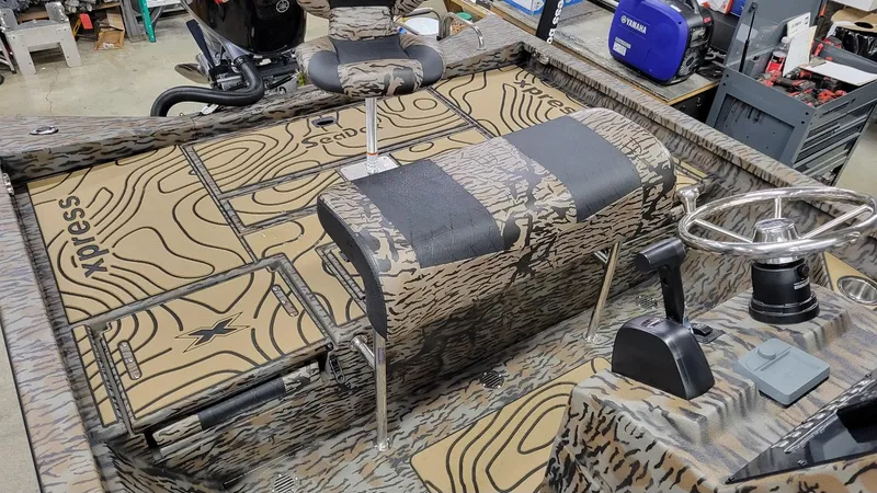Slide: The Image of 2025 Xpress H22 Bay boat interior with Yamaha Vmax 175 SHO engine, camo design. - 21