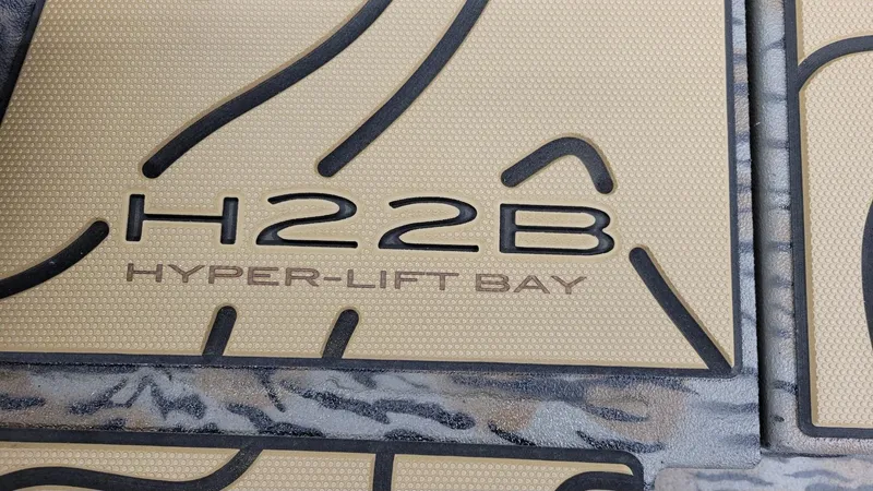 Slide: The Image of 2025 Xpress H22 Bay Hyper-Lift Bay logo detail on textured surface. - 6