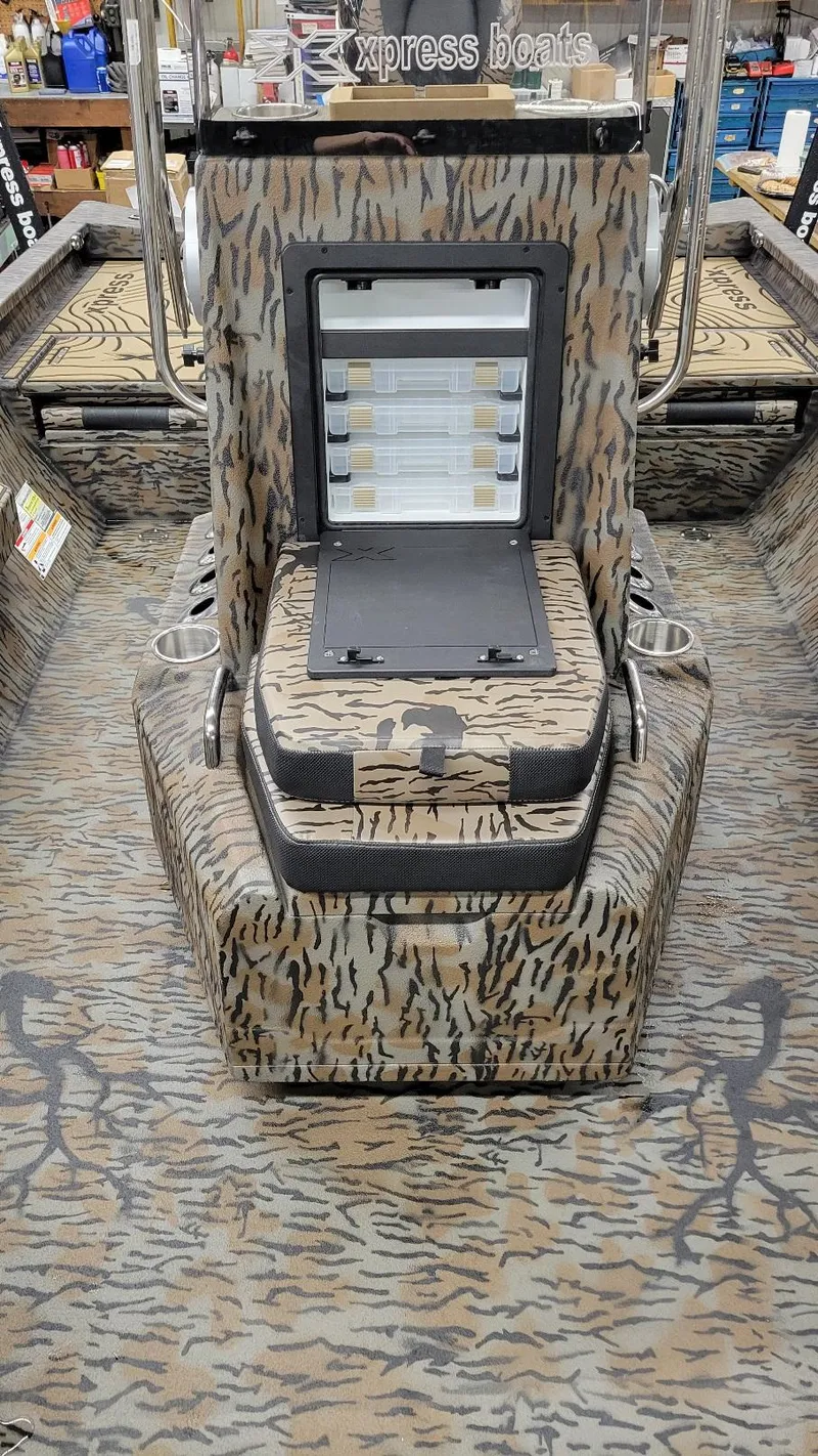Slide: The Image of 2025 Xpress H22 Bay boat interior with camouflage design and storage compartments. - 7