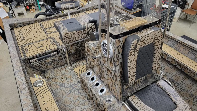 Slide: The Image of 2025 Xpress H22 Bay boat interior with Yamaha Vmax 175 SHO, featuring camo design and seating. - 8