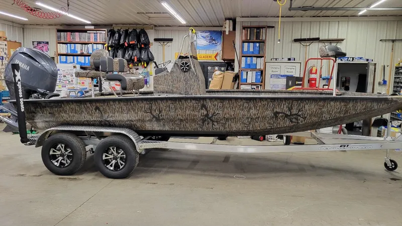 The Image of 2025 Xpress H210 Bay boat with Yamaha 150 engine in a showroom. - 1