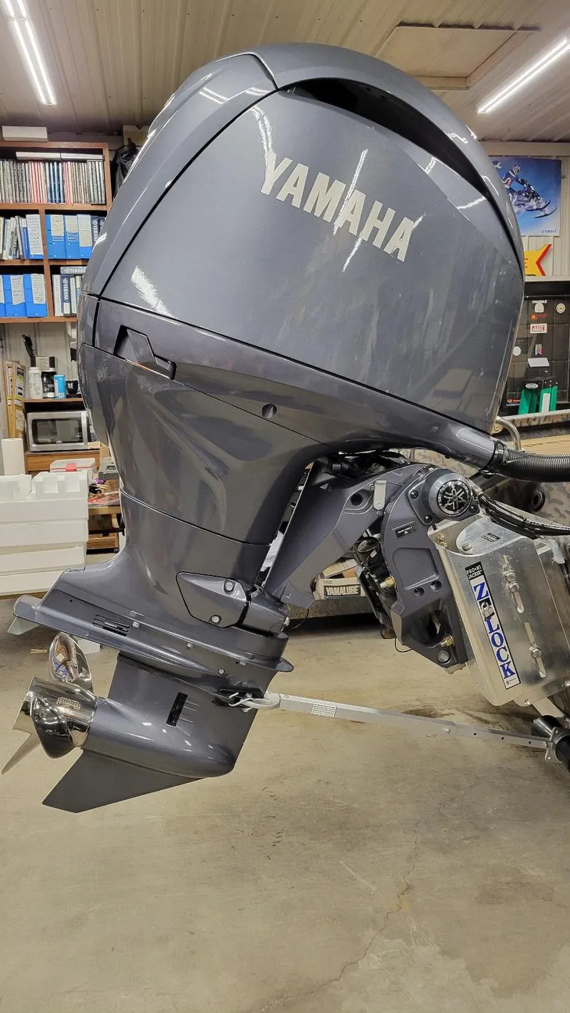 Slide: The Image of 2025 Xpress H210 Bay with Yamaha 150 outboard engine in a workshop setting. - 10