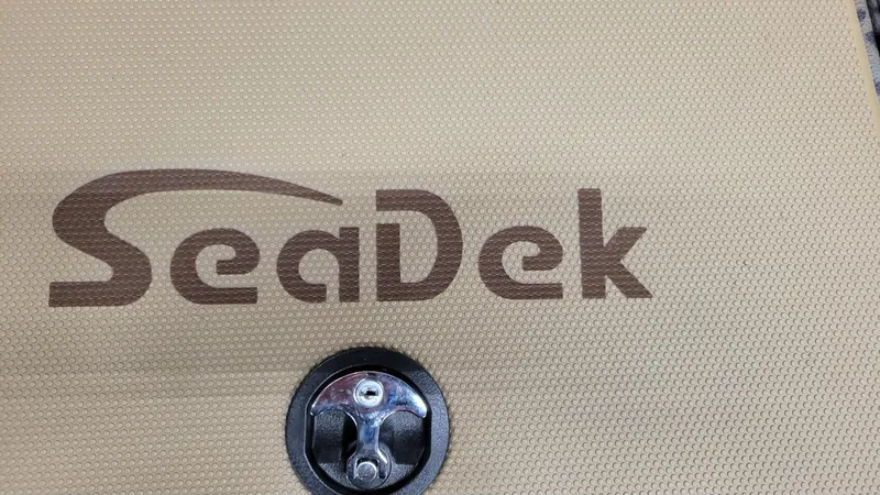 Slide: The Image of SeaDek logo on textured surface of 2025 Xpress H210 Bay boat. - 15