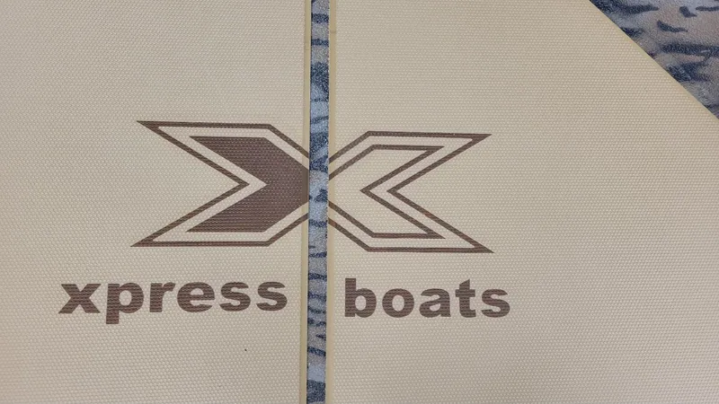 Slide: The Image of Xpress Boats logo on textured surface, 2025 H210 Bay model with Yamaha 150. - 17