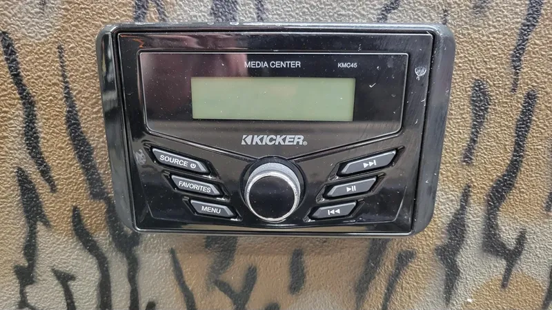 Slide: The Image of Kicker media center KMC45 on Xpress H210 Bay boat dashboard, 2025 model. - 20