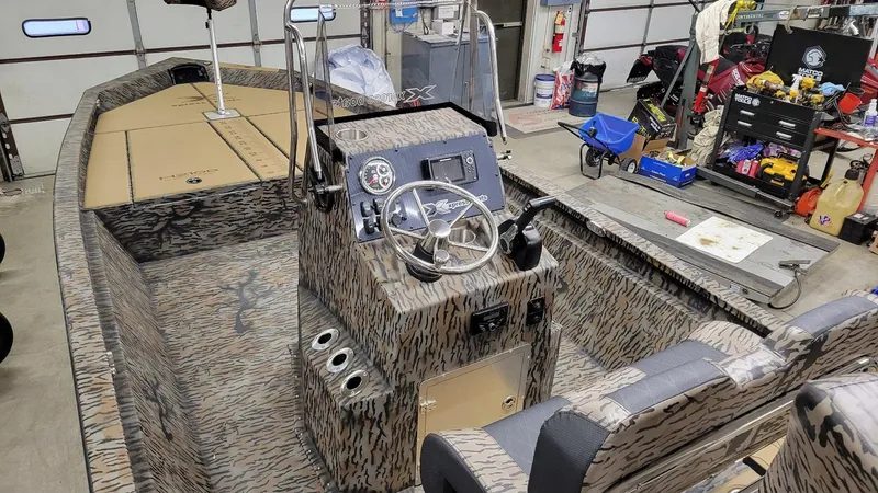 Slide: The Image of 2025 Xpress H210 Bay boat interior with Yamaha 150, camo design, in stock. - 4