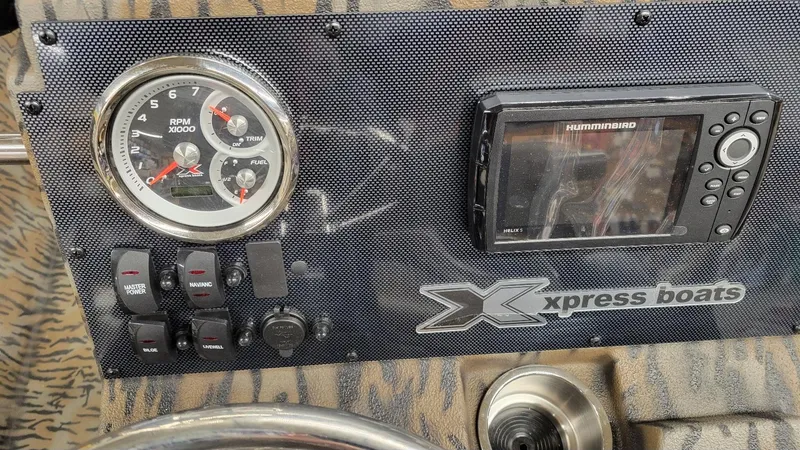 Slide: The Image of Dashboard of 2025 Xpress H210 Bay boat with gauges and Humminbird display. - 8