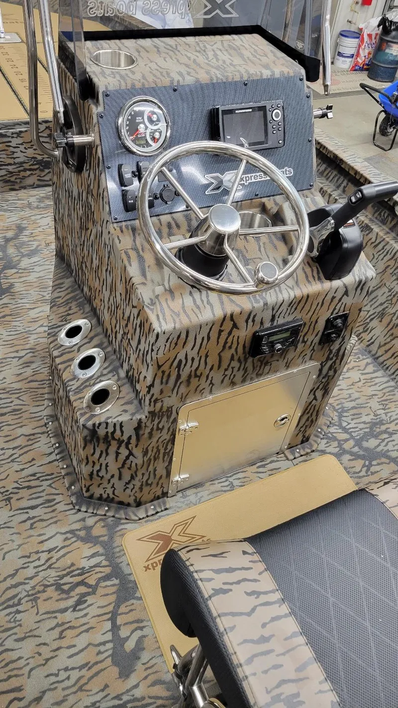 Slide: The Image of 2025 Xpress H210 Bay boat interior with Yamaha 150, featuring camo design and modern controls. - 9