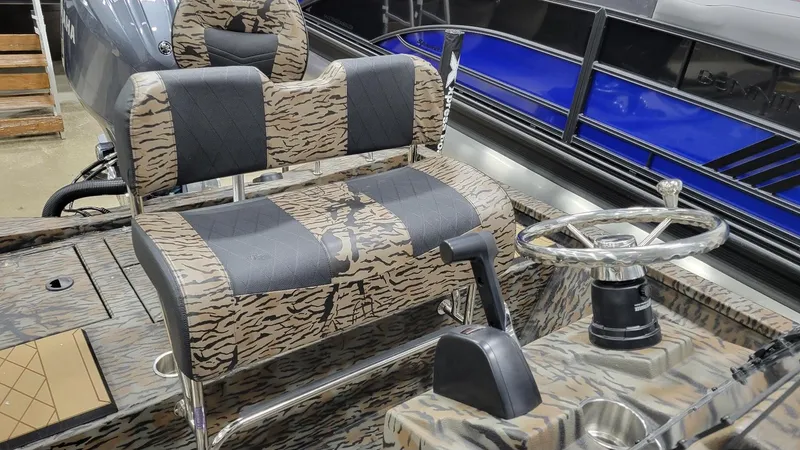 Slide: The Image of 2025 Xpress H210 Bay boat interior with Yamaha F150 engine, featuring camo seating and steering wheel. - 11