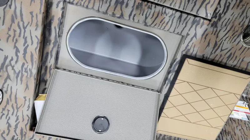 Slide: The Image of 2025 Xpress H210 Bay boat storage compartment with camo pattern. - 13