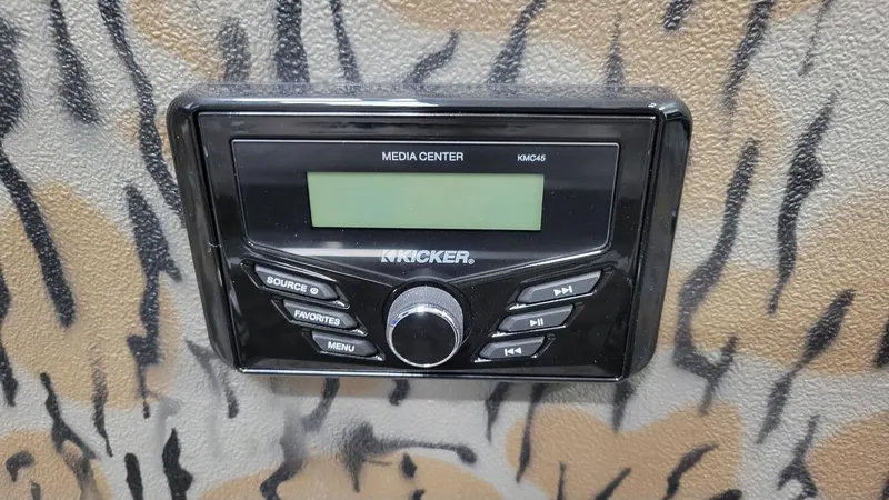 Slide: The Image of Kicker media center in 2025 Xpress H210 Bay boat with Yamaha F150. - 16