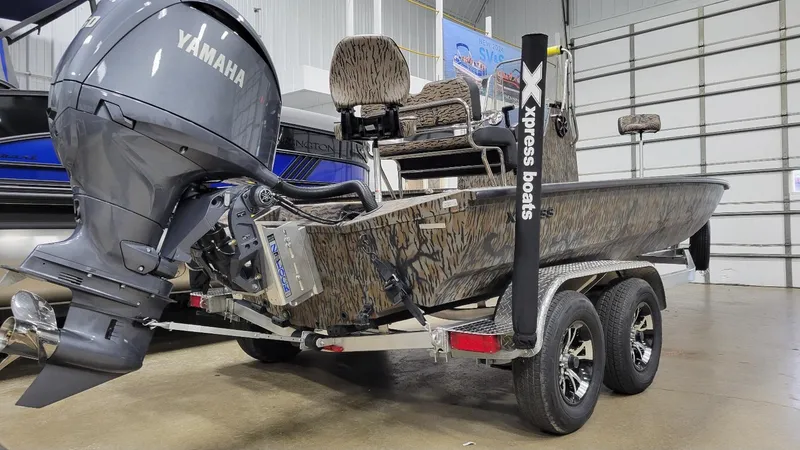 Slide: The Image of 2025 Xpress H210 Bay boat with Yamaha F150 engine in showroom. - 3