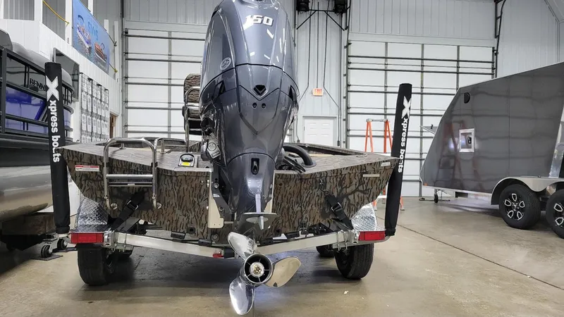 Slide: The Image of 2025 Xpress H210 Bay boat with Yamaha F150 engine on trailer in showroom. - 5