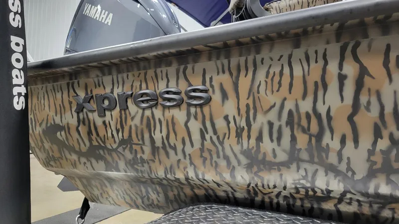 Slide: The Image of 2025 Xpress H210 Bay boat with Yamaha F150 engine, camo design. - 6