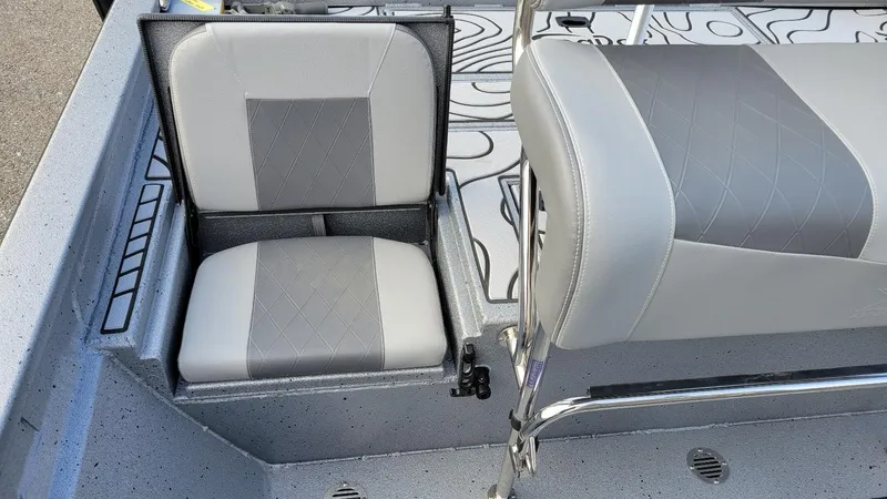 Slide: The Image of 2025 Xpress H22 Bay boat seats with gray upholstery and storage compartment. - 10