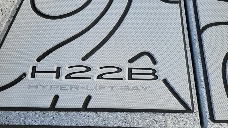 Slide: The Image of 2025 Xpress H22 Bay Hyper-Lift Bay logo detail on textured surface. - 16