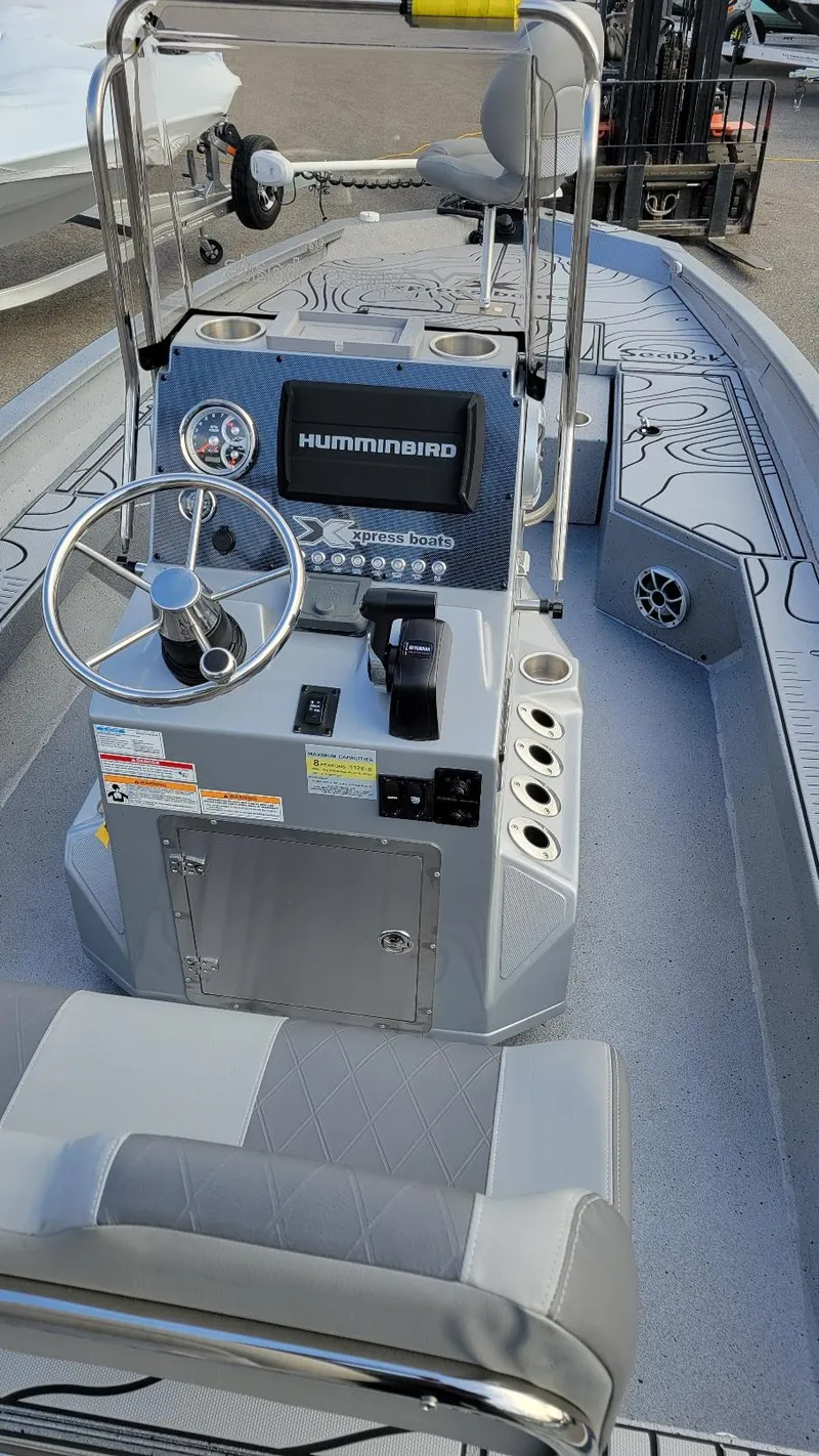 Slide: The Image of 2025 Xpress H22 Bay boat interior with steering console and Humminbird system. - 19