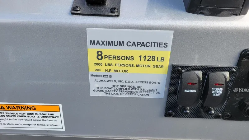 Slide: The Image of 2025 Xpress H22 Bay boat capacity label, 8 persons, 1128 lbs, Yamaha Vmax 200 SHO engine. - 20