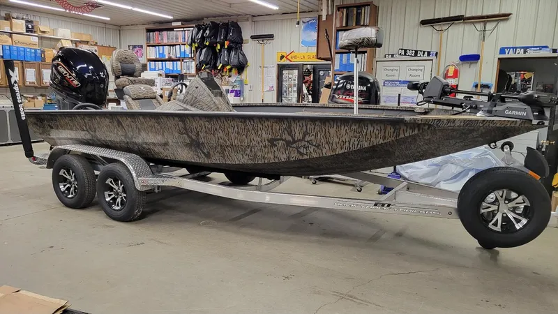 Slide: The Image of 2025 Xpress X19 Pro Bass boat with Yamaha Vmax 200, in stock, displayed indoors. - 1