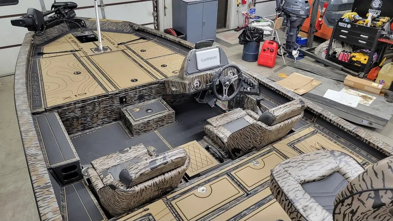 Slide: The Image of 2025 Xpress X19 Pro Bass boat interior with Yamaha Vmax 200, featuring camo design and Garmin electronics. - 12