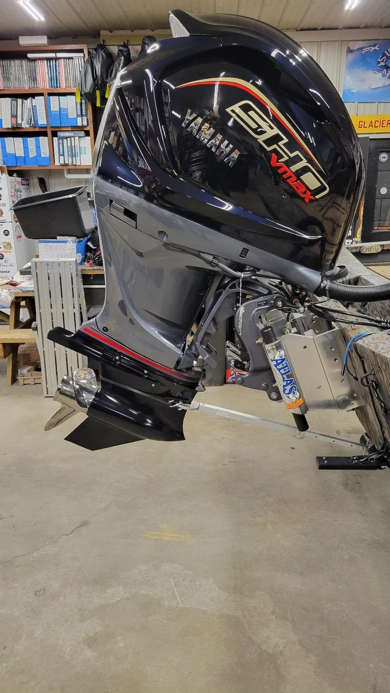 Slide: The Image of 2025 Xpress X19 Pro Bass with Yamaha Vmax 200 engine in a workshop setting. - 2