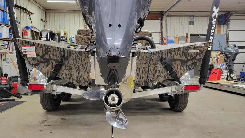 Slide: The Image of 2025 Xpress X19 Pro Bass boat with Yamaha Vmax 200 in a garage setting. - 3