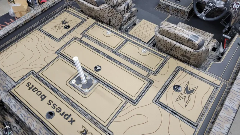 Slide: The Image of 2025 Xpress X19 Pro Bass boat interior with Yamaha Vmax 200, featuring storage compartments and seating. - 5