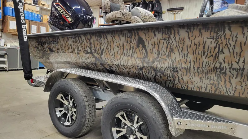 Slide: The Image of 2025 Xpress X19 Pro Bass boat with Yamaha Vmax 200, camo design, on trailer. - 7