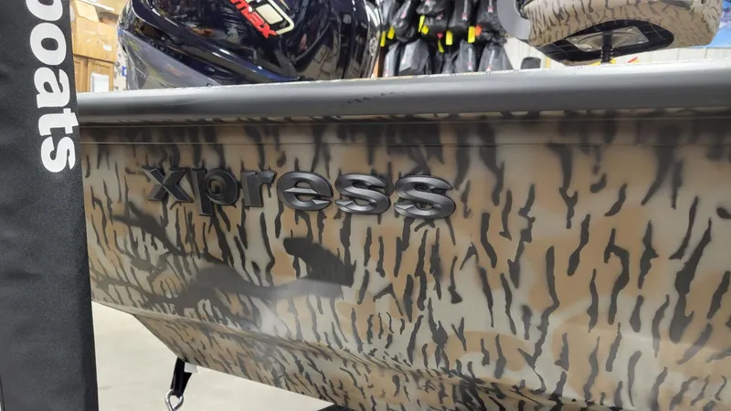 Slide: The Image of 2025 Xpress X19 Pro Bass boat with Yamaha Vmax 200, camo design, in stock. - 8