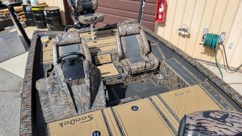 Slide: The Image of 2025 Xpress X19 Pro Bass boat interior with Yamaha 200 Vmax engine, camo design. - 16