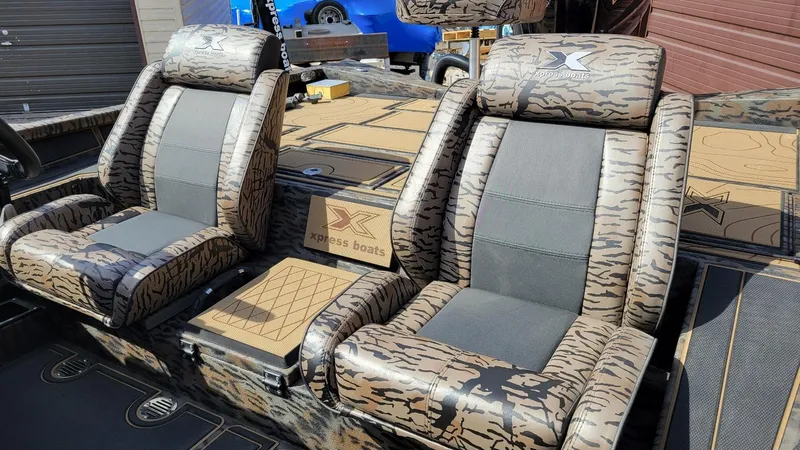 Slide: The Image of 2025 Xpress X19 Pro Bass boat seats with camo design and logo detailing. - 17