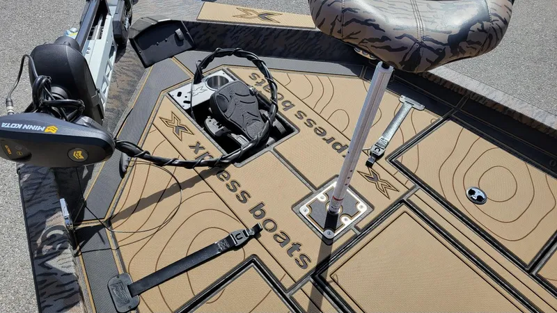 Slide: The Image of 2025 Xpress X19 Pro Bass boat deck with Minn Kota trolling motor and camo seat. - 6