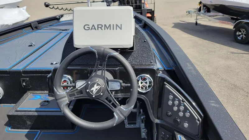 Slide: The Image of 2025 Xpress X21 Pro Bass boat dashboard with Garmin navigation system. - 18