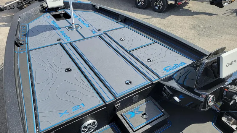Slide: The Image of 2025 Xpress X21 Pro Bass boat deck with SeaDek flooring and Garmin electronics. - 7