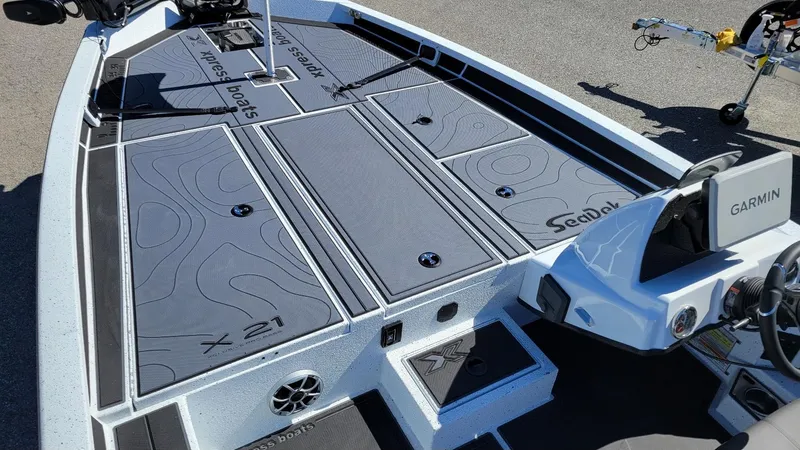 Slide: The Image of 2025 Xpress X21 Pro Bass boat interior with Garmin system and SeaDek flooring. - 18
