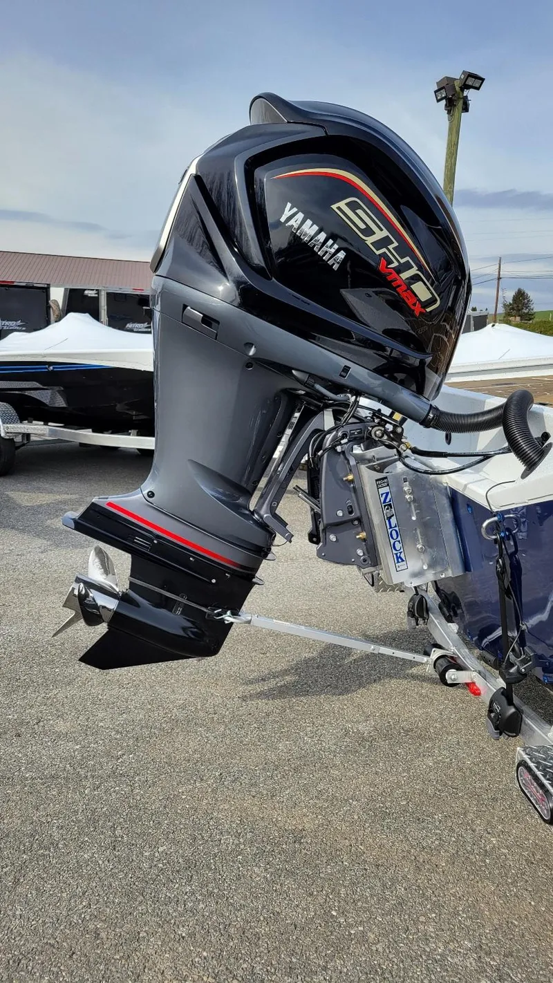 Slide: The Image of 2025 Xpress X23 Bay with Yamaha Vmax 200 SHO outboard motor, parked outdoors. - 15