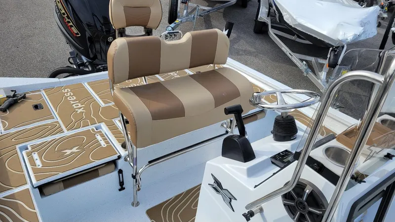 Slide: The Image of 2025 Xpress X23 Bay boat interior with Yamaha Vmax 200 SHO engine, featuring tan seating and controls. - 23