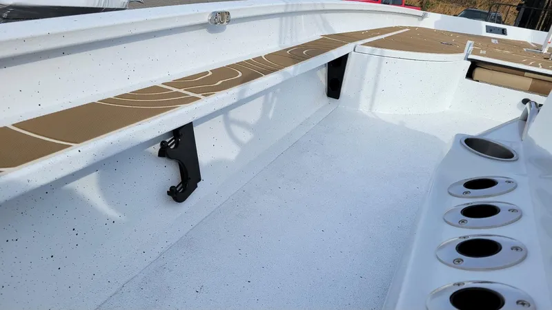 Slide: The Image of 2025 Xpress X23 Bay boat interior with rod holders and storage compartments. - 24