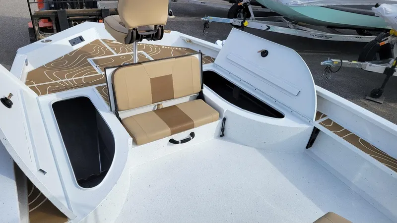 Slide: The Image of 2025 Xpress X23 Bay boat interior with seating and storage compartments. - 4