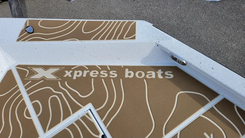 Slide: The Image of 2025 Xpress X23 Bay boat deck with logo and textured design. - 5