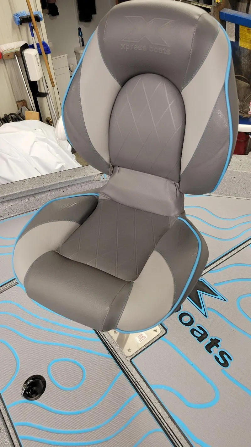 Slide: The Image of 2025 Xpress H22 Bay boat seat with gray and blue design. - 10