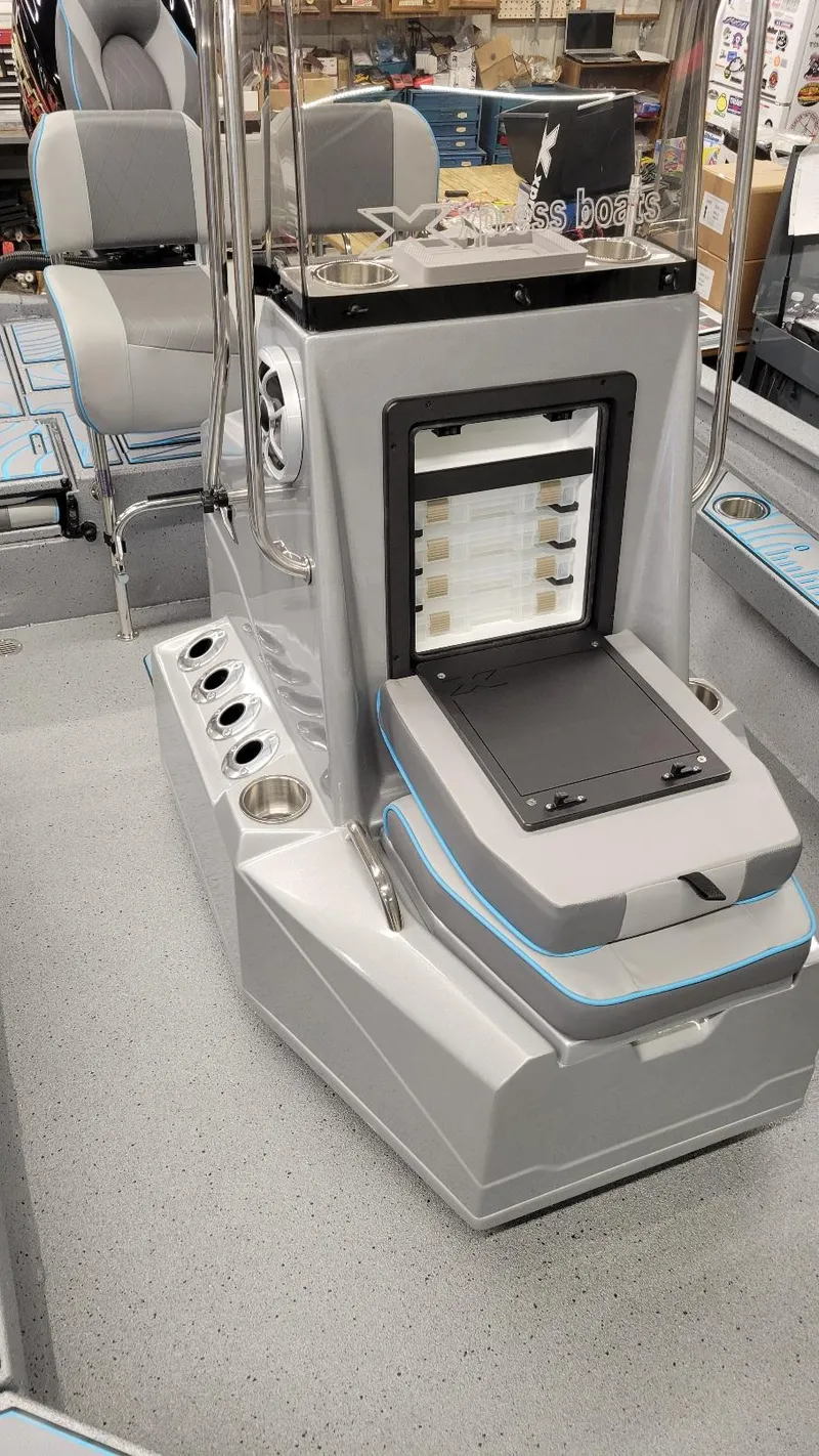 Slide: The Image of 2025 Xpress H22 Bay boat interior with Yamaha Vmax 200 SHO, featuring seating and storage. - 12