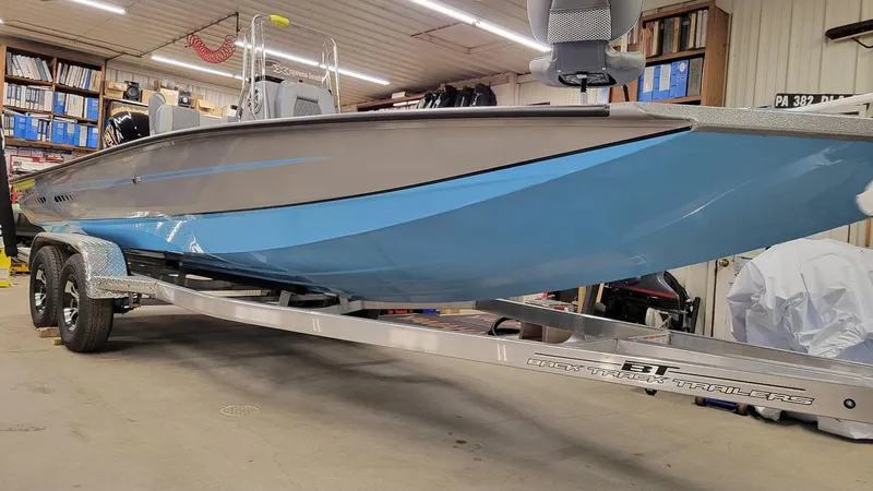 Slide: The Image of 2025 Xpress H22 Bay boat with Yamaha Vmax 200 SHO, displayed indoors on trailer. - 16