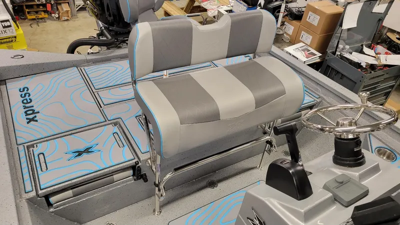 Slide: The Image of 2025 Xpress H22 Bay boat interior with Yamaha Vmax 200 SHO, featuring stylish seating and controls. - 23