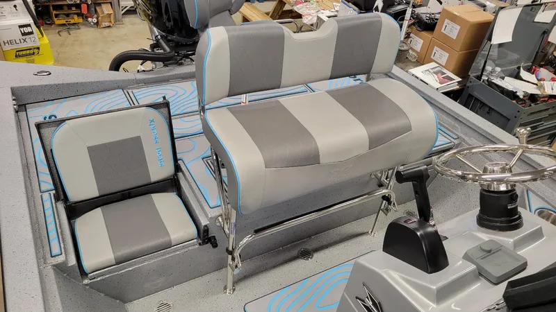 Slide: The Image of 2025 Xpress H22 Bay boat interior with Yamaha Vmax 200 SHO, featuring gray seating and steering console. - 24