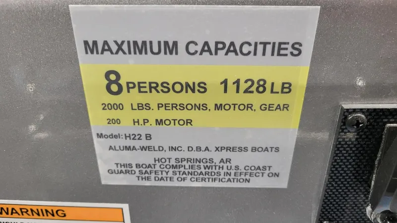 Slide: The Image of 2025 Xpress H22 Bay boat capacity label: 8 persons, 1128 lbs, 200 HP motor. - 25