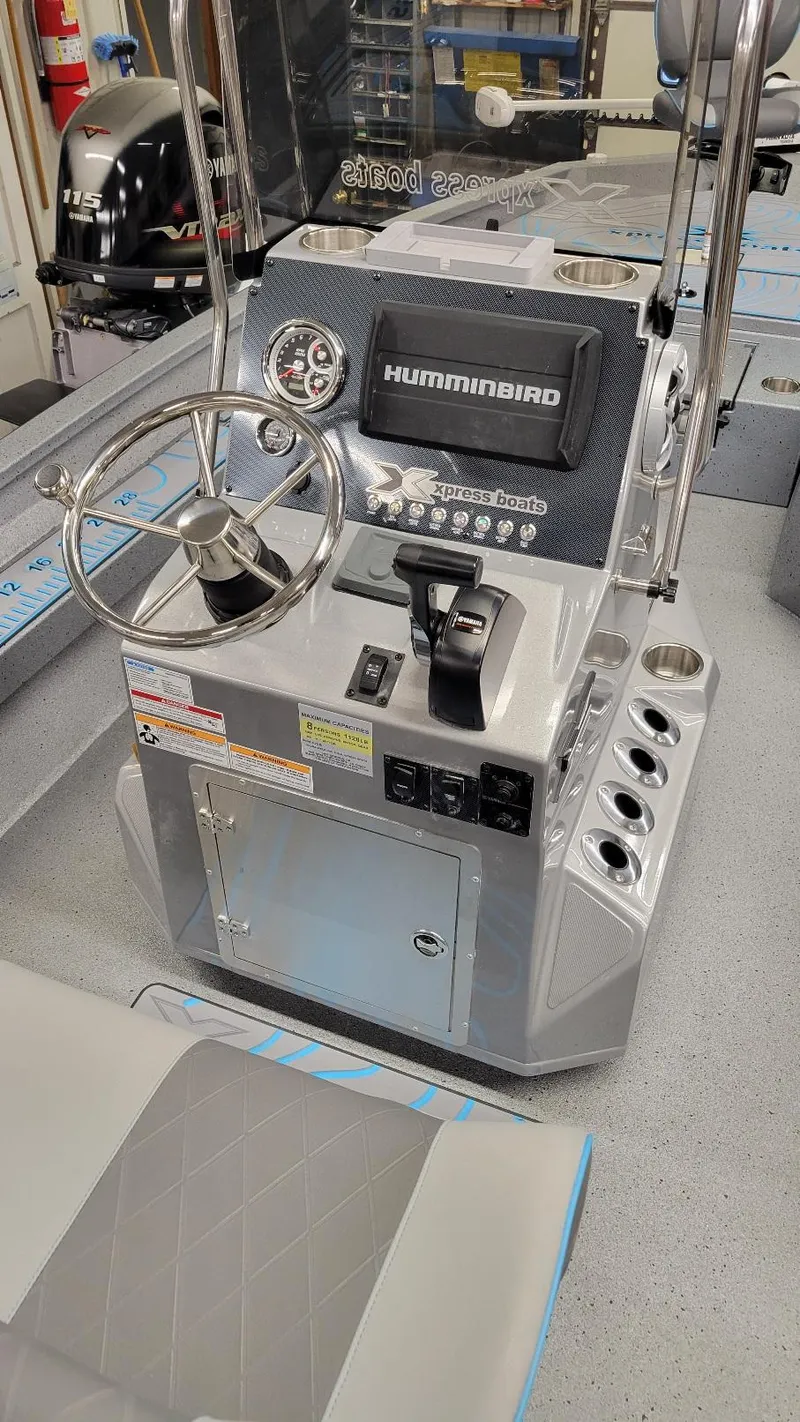 Slide: The Image of 2025 Xpress H22 Bay boat console with Yamaha Vmax 200 SHO engine, featuring Humminbird electronics. - 26